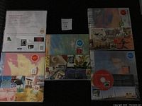Top-down view of five sealed Canada Post annual stamp collection albums (2001-2005) with various cover art and price labels visible