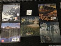 Five sealed Canada Post Canada Collection annual stamp albums arranged showing front covers