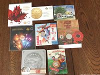 Overview of eight RCM coin collections in original sealed packaging, including themed artwork and commemorative issues.