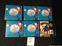Five 2015 Superman $20 For $20 .999 silver coins in blue collectible folders plus one Canada Post coin and stamp set with colorized coin.