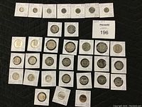 Full view of 33 coins arranged on a black background with MaxSold card