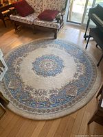Full view of the round area rug in a room, showing overall pattern and size relative to furniture.