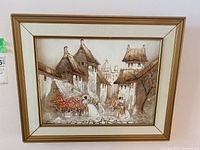 Framed mixed media artwork showing vintage town street scene with three women in period dresses and domed building in background.