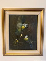 Full view of one framed bird painting showing two birds, one in flight, signed Bruce
