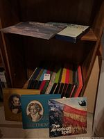 Boxed sets of classical and other music albums on wooden shelf, including Beethoven album covers and sets with colorful spines.