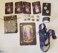 Full collection laid out flat: enamel hourglass pins (4, including 1 pastel colored), planet pins (3), celestial lanyard, decorated tape, celestial stickers, and gold star moon gift bag.