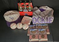 Full lot photo showing baseballs, jersey, cap, tokens, and coke bottles
