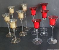 Full set of 10 glass votive candle holders, 5 gold and 5 red, arranged in staggered heights with varying heights from 8 to 12 inches.