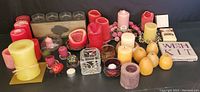 Wide view showing the full collection of candles of various sizes, colors and candle holders along with some incense and Wish Kit.