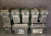 Group of 10 black plastic latching cases stacked in two rows showing front with handles and latch details. All cases have '2A WAREHOUSE' marked on the side.