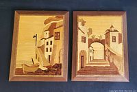 Pair of framed Italian marquetry wooden inlay wall art pieces showing seaside scenes, one with a small chip on frame edge.