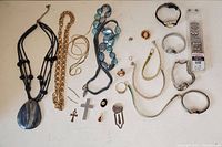 Top view showing entire assortment of costume jewelry and watches arranged on a flat surface.