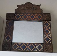 Front view of the square mirror with Talavera tile and punched tin frame, showing overall design and size.