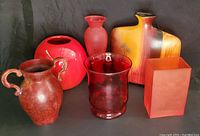 Lot of 6 vases arranged on a dark surface showing colors, shapes, and styles