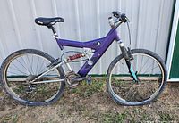 Full side view of the purple Bianchi Y frame mountain bike showing overall structure, tires flat, and ground placement.