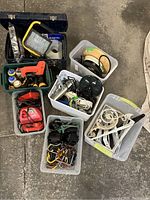 Wide overhead view showing bins with tools, cords, shelf brackets, hooks, and red power tools.