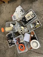 Overview image showing seven bins with a mix of electrical parts including plates, cords, testers, and ductless filter parts