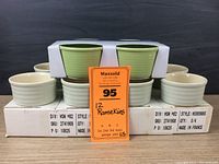 12 ramekins including 4 light green Chantal ramekins in box and 8 cream and pale green Emile Henry ramekins in boxes