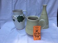 Ethan Allen red ware pitcher, tall bud vase, and white ceramic hand-painted pitcher displayed against white background with lot tag attached to pitcher.