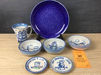 Wide shot showing all six Hadley Pottery ceramics and one purple speckled hand-thrown plate