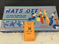 Box top showing Hats Off game branding and clown illustrations.