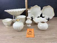 Full view of the 10-piece Lenox porcelain set including various bowls, vases, and compote, all featuring gold rims.