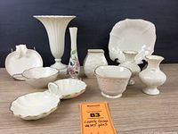 Group photo of 10 Lenox ceramic vases and dishes on wood surface with black background