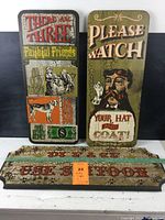 Three wooden vintage style signs painted with retro graphics and text, showing worn crackle paint finish, arranged side by side and stacked