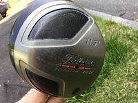 Photo showing the clubface and loft marking of the Titleist Titanium 983k driver, 11.5 degrees, with wear visible.