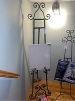 Wide shot of easel holding canvas and another boxed art supply