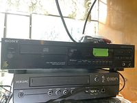 Sony CD player on top of Ion VCR showing front panel controls and logos
