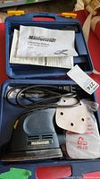 Mastercraft palm sander in blue plastic carrying case with accessories and manual