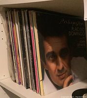 Side view of vinyl records showing a range of album covers including Placido Domingo and John Denver