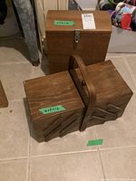 Closed view of the wooden multi-level fold-out sewing basket with handle, alongside the closed lockable wooden storage box.