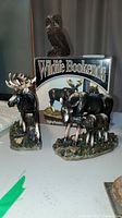 Pair of wildlife-themed bookends, one moose and one owl, with box labeled 'Wildlife Bookends'