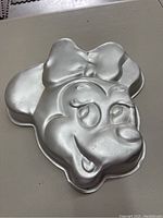 Aluminum Minnie Mouse shaped cake pan with detailed face and bow 