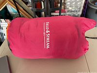 Pink Field & Stream sleeping bag in stuff sack showing brand and approximate size 6'1".