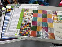 Layout of calendar bulletin board set and colorful reward charts in packaging