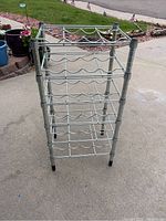 Image of the metal wire wine rack showing its vertical design and five tiers for bottle storage.