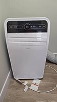 Front view of white portable air conditioner with control panel and digital display