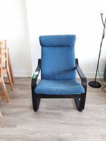 Front view of the armchair showing wood frame and blue upholstery