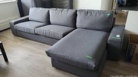 Assembled view of sectional showing chaise on right, three seat cushions and back cushions in place