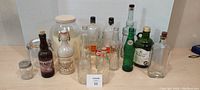 Wide view of entire collection of vintage bottles including soda, mead, pickling jar, and other glass bottles