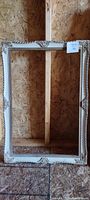 Full view of the entire vintage picture frame showing its rectangular shape and decorative carvings.