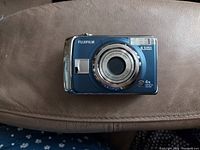 Top front view of the FujiFilm FinePix A820 camera showing the lens, branding, and condition.