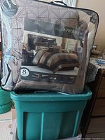 Packaged 8-piece bedding set showing photo of the comforter on the front and details of included items.