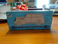 Photo of original box showing 1937 Chevy Sedan Delivery blue illustrated packaging, marked Limited Edition by Liberty Classics.