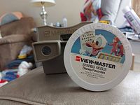 GAF View-Master vacuum tube viewer with one Disney stereo reel disc labeled 'Disney Favorites' featuring Donald Duck and Pluto.