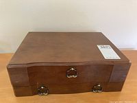 Closed wooden canteen box with brass handles and hinges