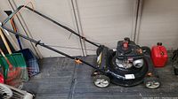 Full view of black Remington gas push lawn mower model RMA1S5 with grass catcher and wheels.